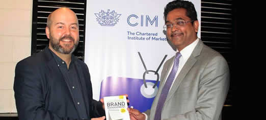 Paul Hitchens prsenting Chris Diaz, Marketing Director of Kenya Airways with a copy of Succesfful Brand ManagementKenyan